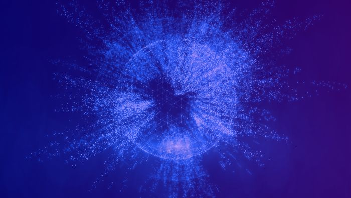 Abstract digital artwork of a glowing blue sphere made up of thousands of light particles, radiating outward on a dark purple background. The center of the sphere features a faint hexagonal grid, giving a sense of structure, data, or network connectivity. The image conveys themes of technology, digital transformation, and interconnected systems.