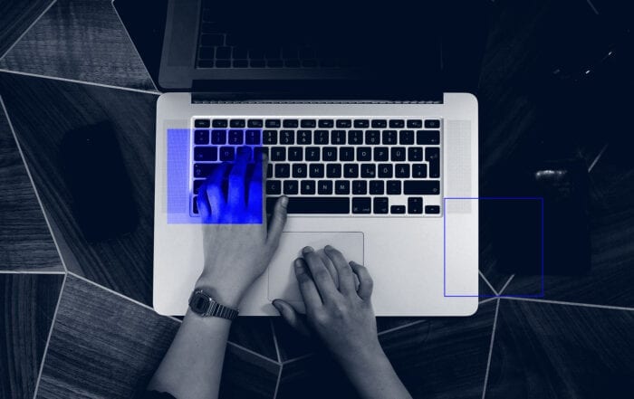hands typing on a macbook pro