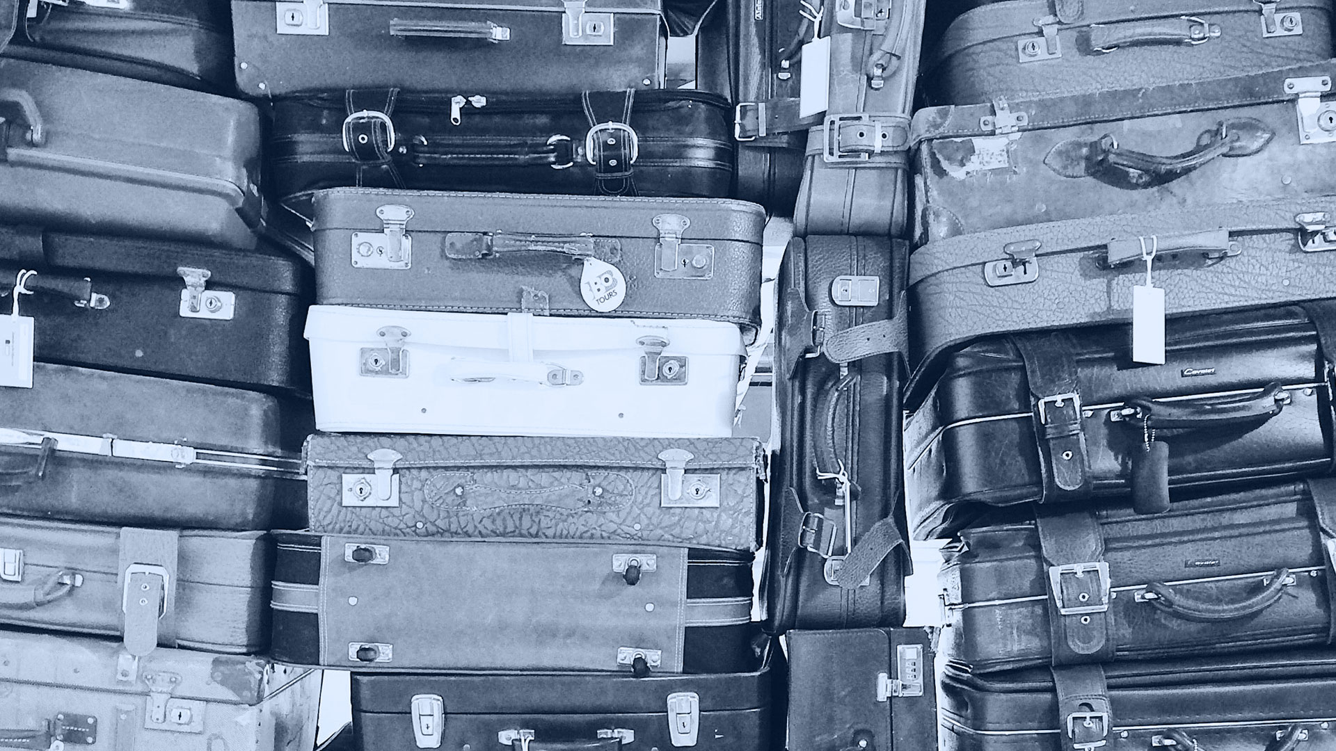 Suitcases stacked for travel.