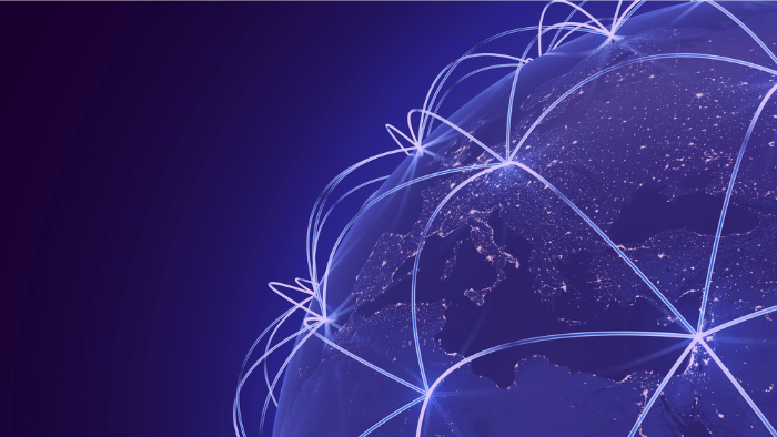 A digital rendering of Earth from space at night, focused on Europe and surrounding regions, with illuminated city lights. Glowing white arcs connect various points across the globe, symbolizing global digital connectivity and international networks. The background is a deep blue to purple gradient, enhancing the futuristic and technological theme.